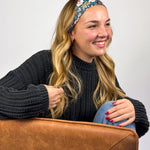 Woman wearing the Keely Floral on Black headband, showcasing its versatile 3-in-1 twist style and buttery-soft, non-slip fabric, ideal for work or play.