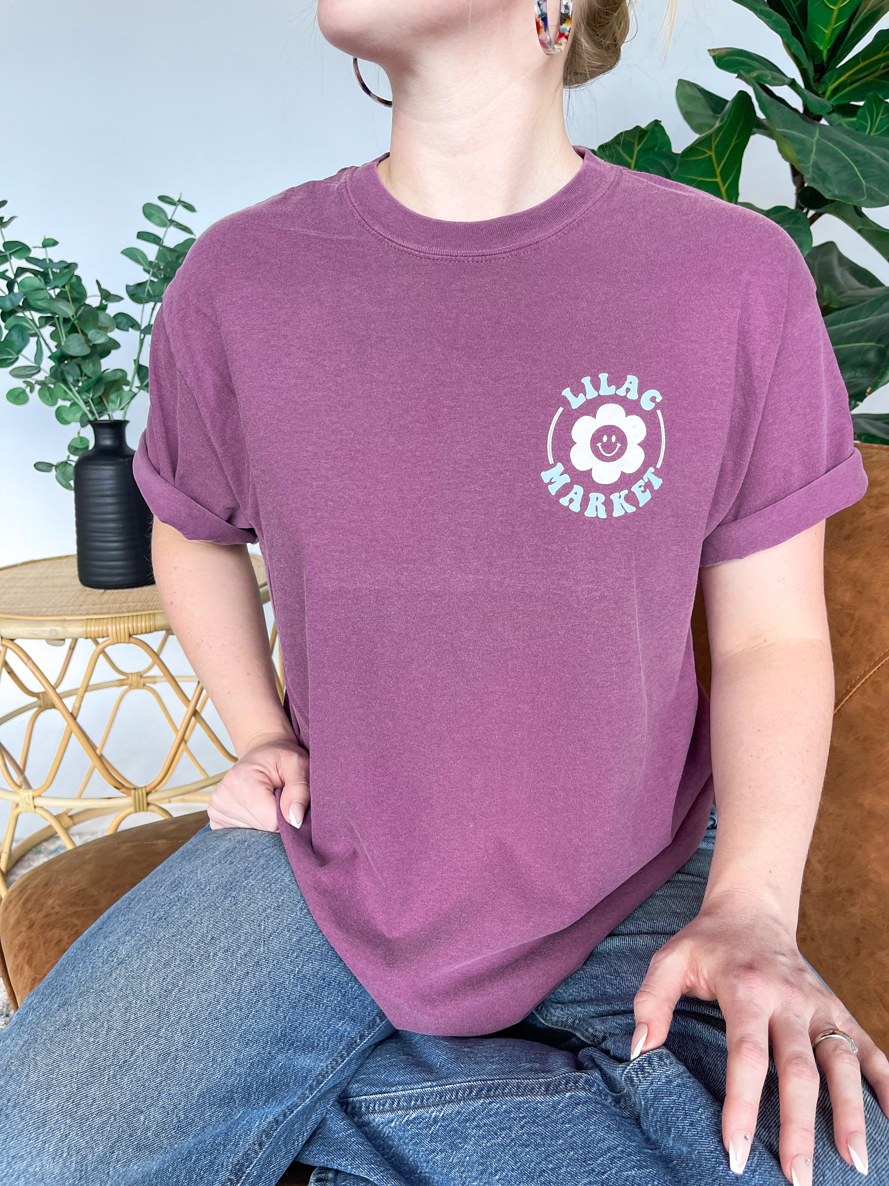 Adult women's vintage berry colored oversized tee shirt with a small Lilac Market logo on the front and a 70's vintage print saying "Lilac Market Headbands" in orange, blue, tan and lilac on the back