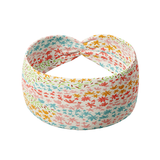Emily Floral in Ivory headband featuring lines of pink, blue, red yellow and green flowers outlines, crafted from a buttery-soft, ultra-stretchy poly-knit blend, designed for versatility and comfort.