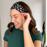 Woman with long hair confidently smiles in the You're My Lucky Charm headband, the perfect non-slip hair accessory for all day wear.