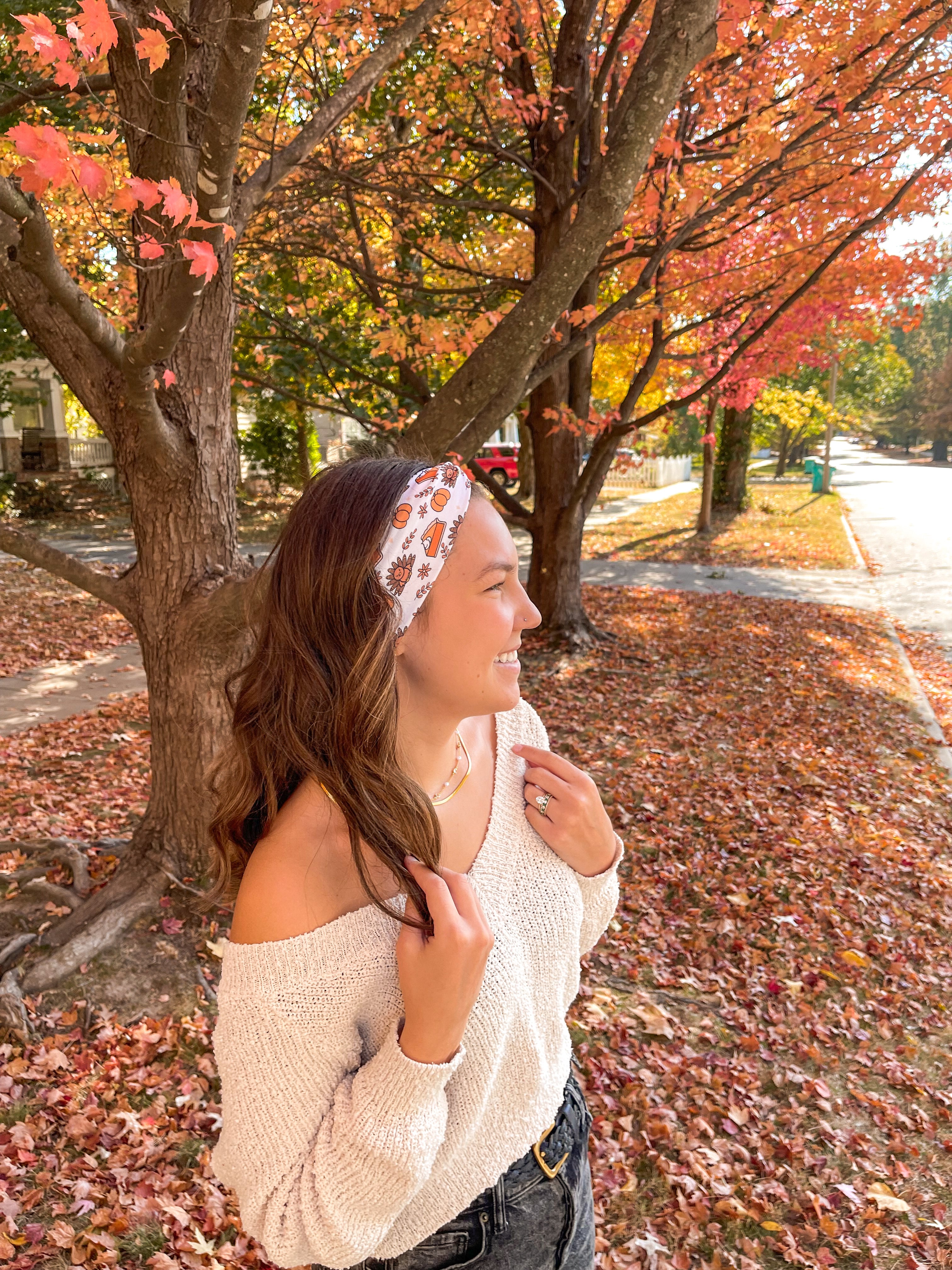 Woman smiling confidently in front of a tree, wearing the Sweet as Pie headband by Lilac Market Headbands, showcasing its versatile, non-slip design.