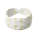 Goldie Floral on Ivory headband featuring small butter yellow flowers, crafted from a buttery-soft, ultra-stretchy poly-knit blend, designed for versatility and comfort.