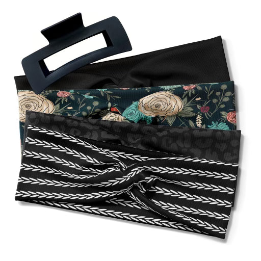 A close-up of five black headbands from the Black Pack, including Solid Black, Jen Floral on Black, Onyx Leopard, Harvest on Black, and the Black Essential Lilac Clip.