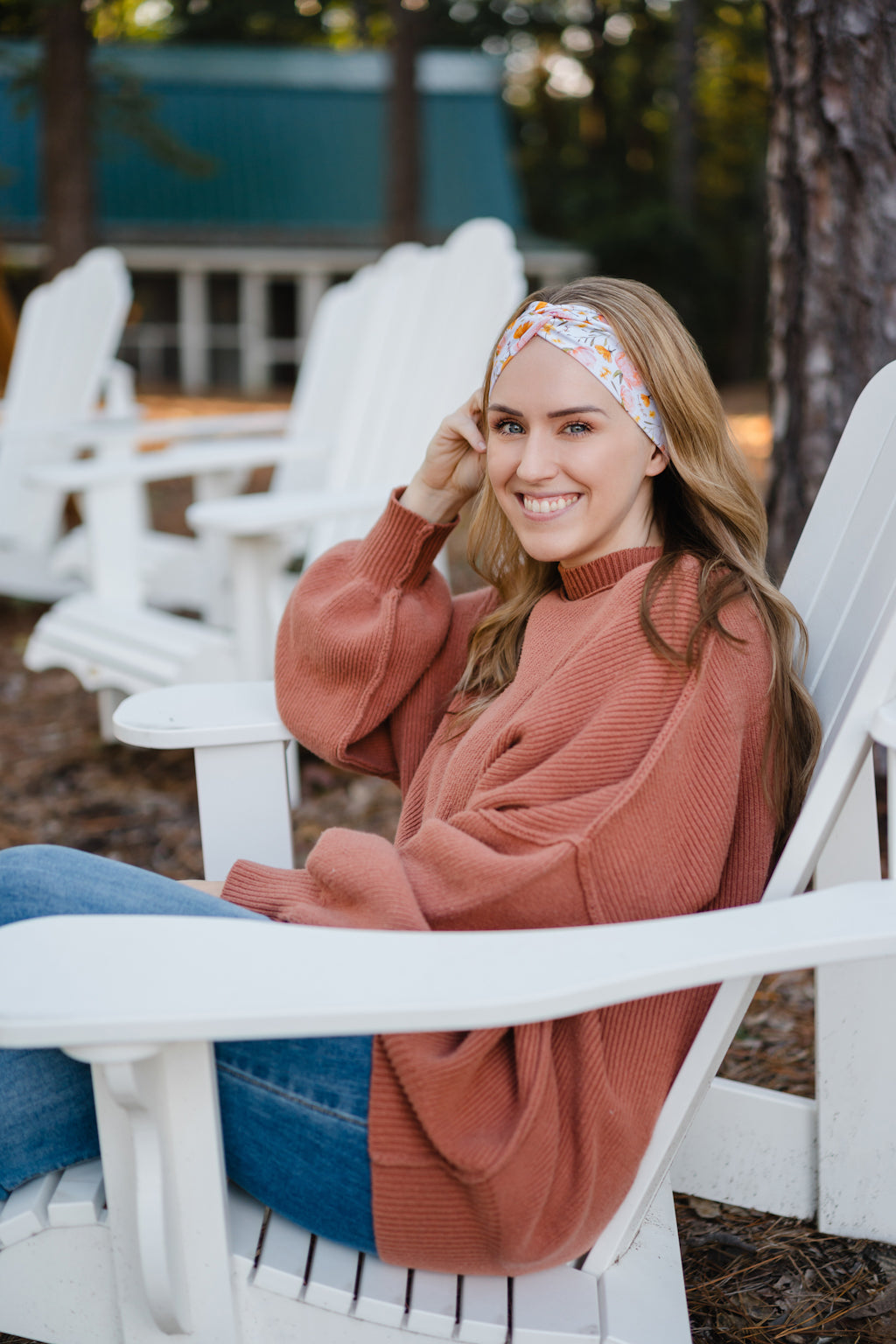 Woman wearing the Flourish headband, showcasing its versatile 3-in-1 twist style and cozy fall charm, part of The Jen Hamilton Collection.