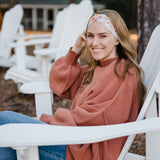 Woman wearing the Flourish headband, showcasing its versatile 3-in-1 twist style and cozy fall charm, part of The Jen Hamilton Collection.