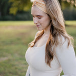 Woman smiling outdoors, wearing the Bring the Weather headband from The Jen Hamilton Collection, showcasing its versatile, non-slip, buttery-soft design.