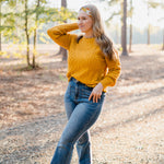 Woman wearing the Golden Harvest headband, part of the Jen Hamilton Collection, showcasing its versatile 3-in-1 twist style, perfect for workouts, long shifts or daily wear.