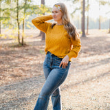 Woman wearing the Golden Harvest headband, part of the Jen Hamilton Collection, showcasing its versatile 3-in-1 twist style, perfect for workouts, long shifts or daily wear.