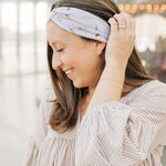 Woman smiling, wearing The Corey headband, a versatile and functional poly-knit blend from The Sarah Wallace Collection, the perfect accessory for easy hairstyles.