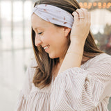 Woman smiling, wearing The Corey headband, a versatile and functional poly-knit blend from The Sarah Wallace Collection, the perfect accessory for easy hairstyles.