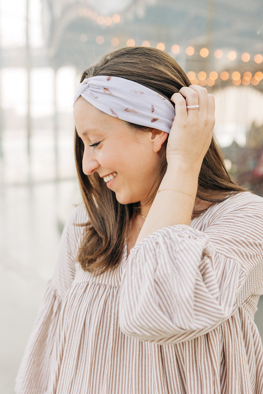 Woman smiling, wearing The Corey headband, a versatile and functional poly-knit blend from The Sarah Wallace Collection, the perfect accessory for easy hairstyles.
