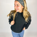 Woman wearing The Enchanted Garden headband, showcasing its versatile 3-in-1 twist style and buttery-soft, non-slip fabric, ideal for work or play.