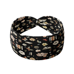Midnight Mystery black headband featuring floral blooms, stacks of books and open books, crafted from a buttery-soft, ultra-stretchy poly-knit blend, designed for reliable non-slip comfort.
