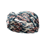 The Great Wave headband features a cherry blossom and waves design, made from a soft, stretchy poly-knit blend for versatile, non-slip wear.