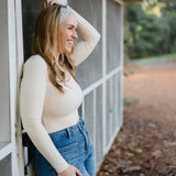 Beautifully Unconventional headband, worn by a smiling woman with long hair, showcasing its versatile 3-in-1 twist style and comfortable fit from the Jen Hamilton Collection.