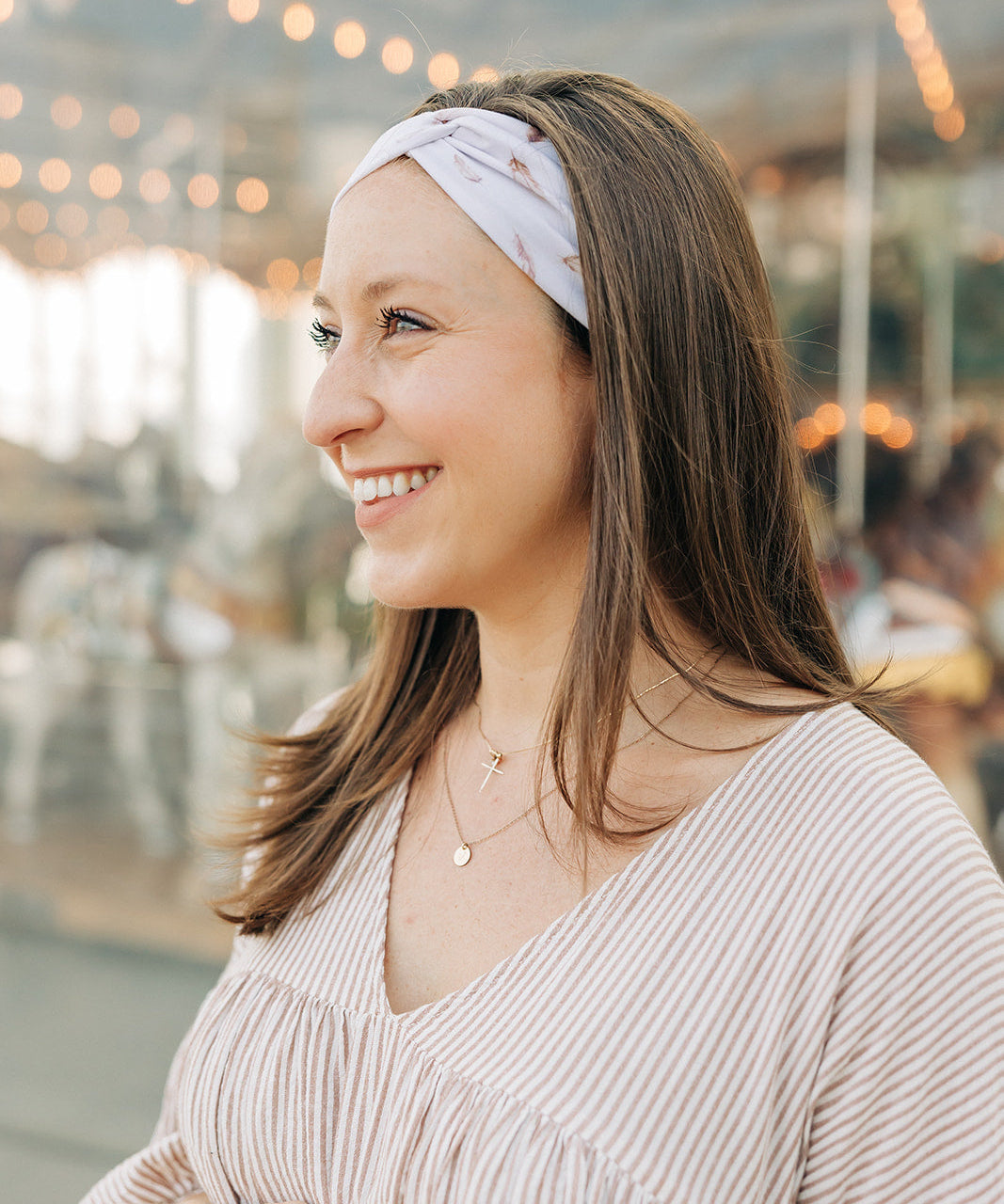 Woman smiling, wearing The Corey headband, a versatile and functional poly-knit blend from The Sarah Wallace Collection, the perfect accessory for easy hairstyles.