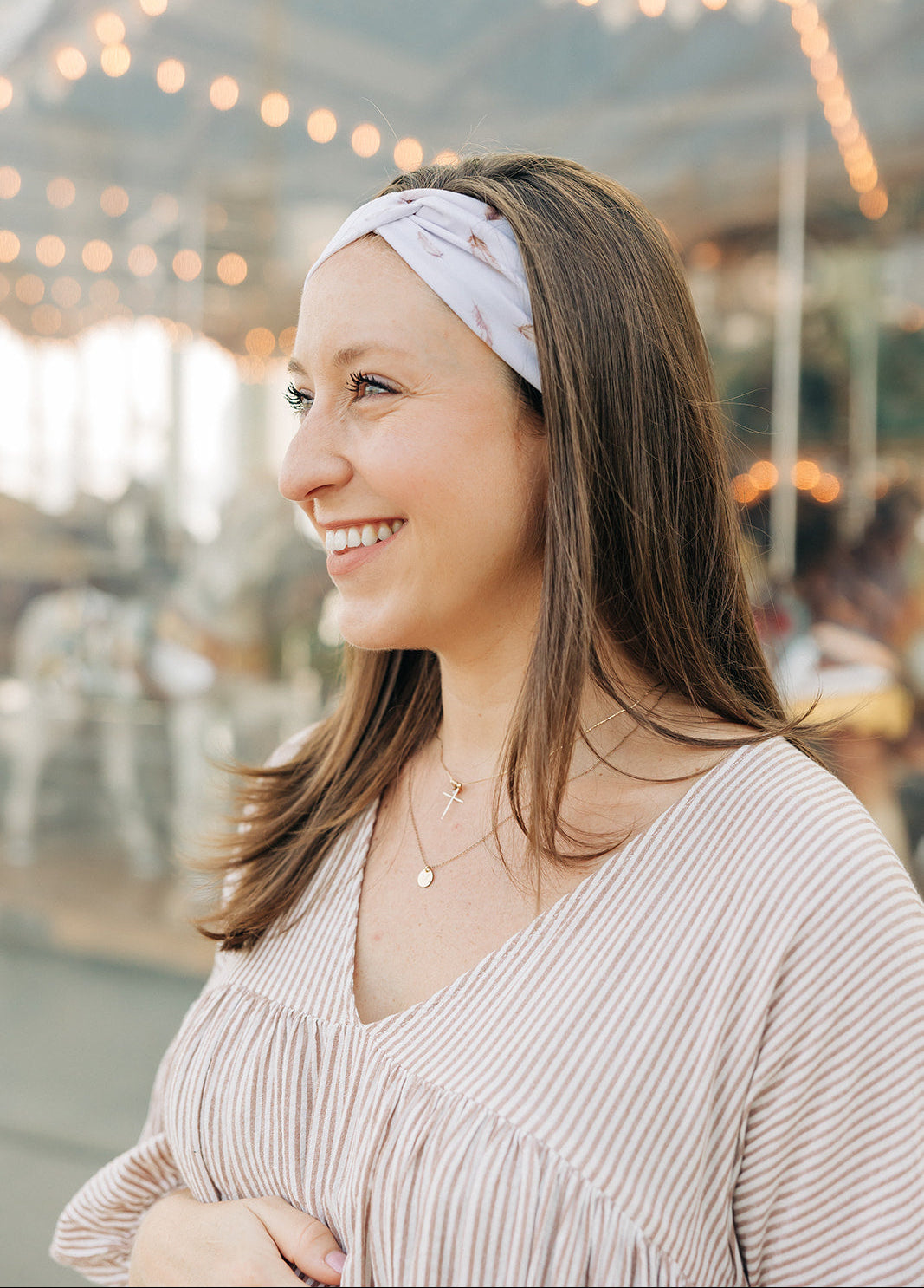 Woman smiling, wearing The Corey headband, a versatile and functional poly-knit blend from The Sarah Wallace Collection, the perfect accessory for easy hairstyles.