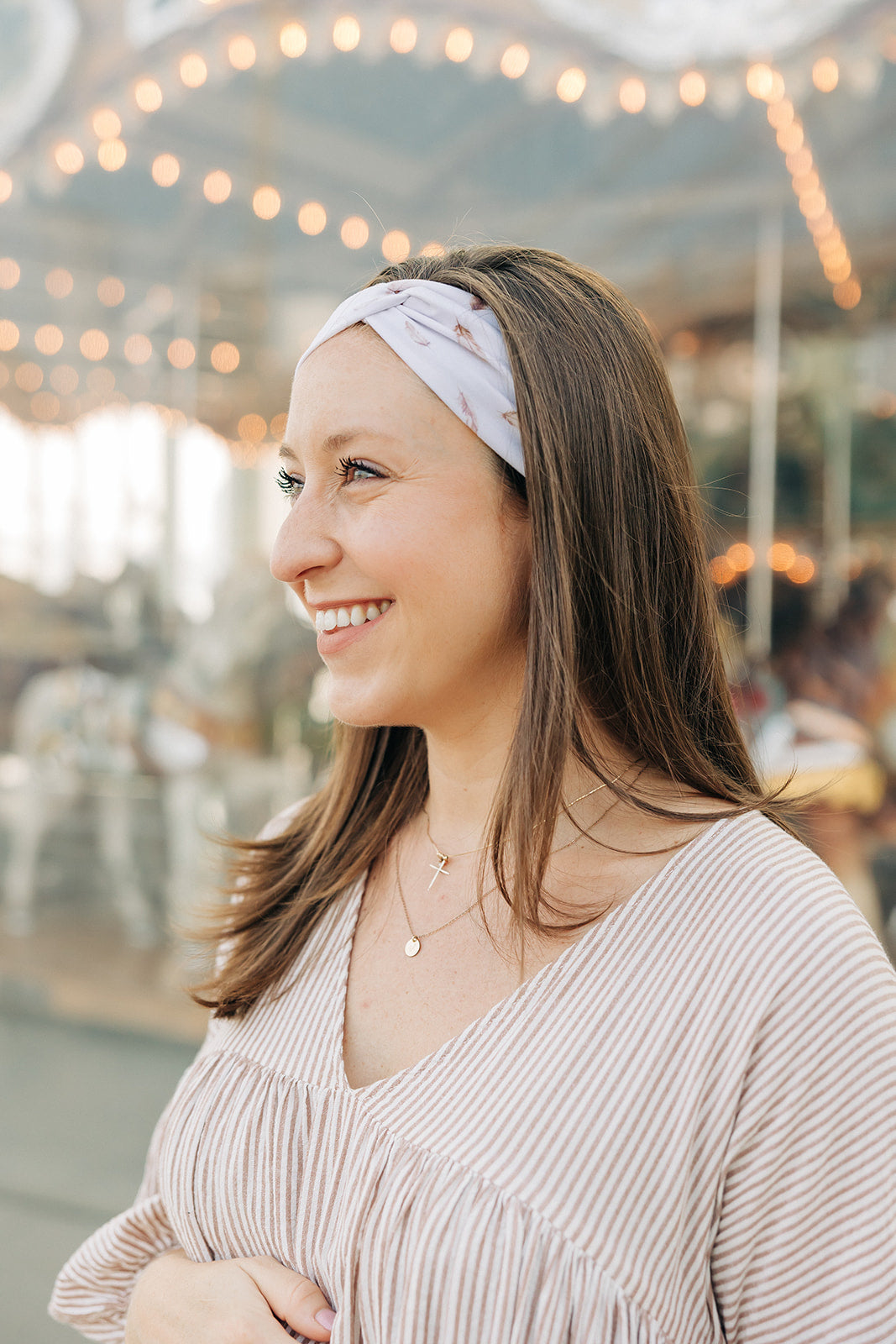 Woman smiling, wearing The Corey headband, a versatile and functional poly-knit blend from The Sarah Wallace Collection, the perfect accessory for easy hairstyles.