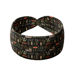 The Enchanted Garden black headband features books and plants design, made from a soft, stretchy poly-knit blend for versatile, non-slip wear.