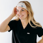 A nurse smiling with long hair while wearing theHeeler at Heart headband for cute hairstyles and comfortable all-day wear.