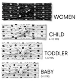 Adult women, child, toddler and baby headbands with black adult size with white cursive that says "mama" with white flowers in between, and white child, toddler and baby headbands with cursive that says "mini" and black flowers in between