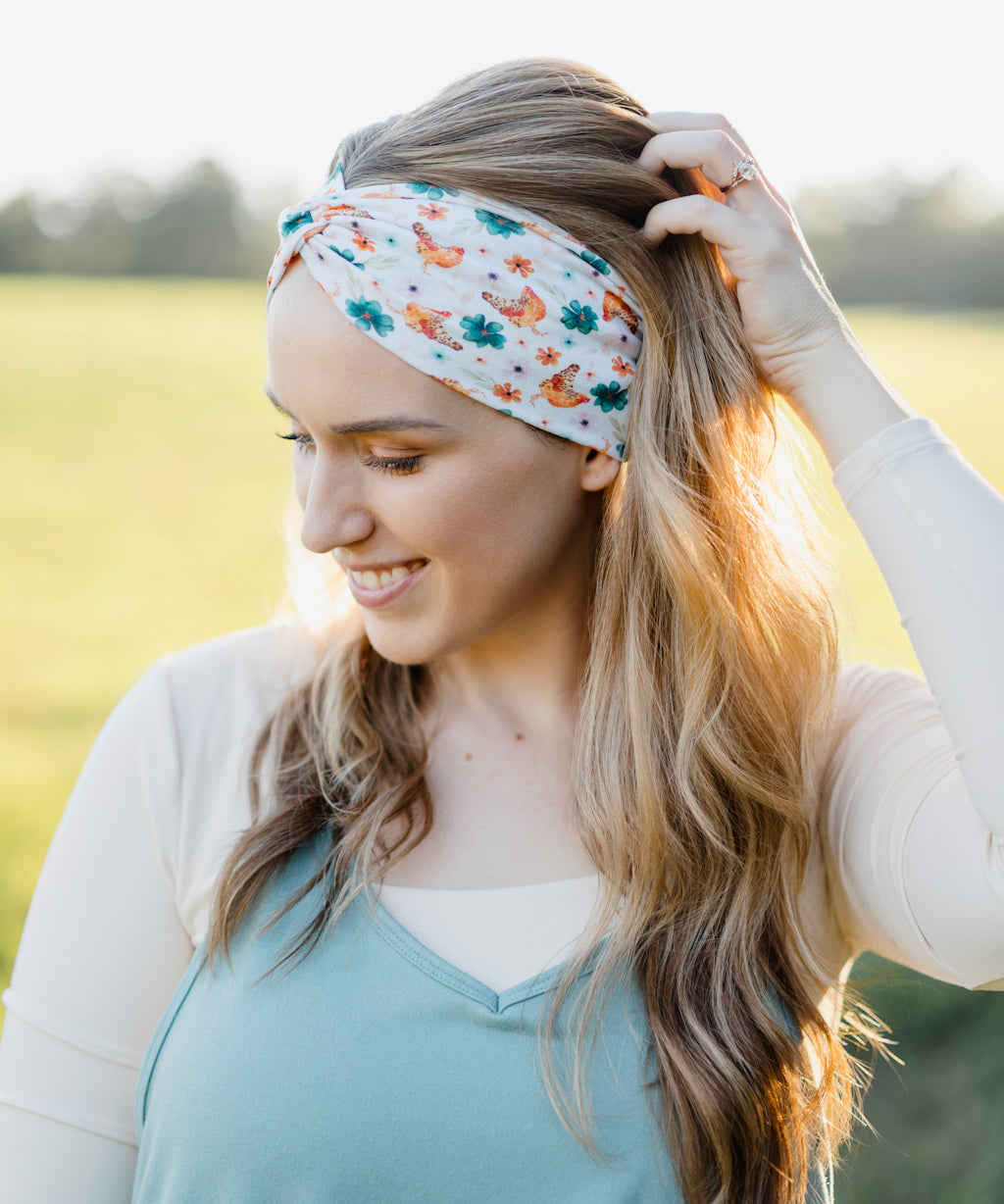Hen & Harvest headband worn confidently by a woman with long hair, highlighting its twist style and versatility for workouts, long shifts, or play days.