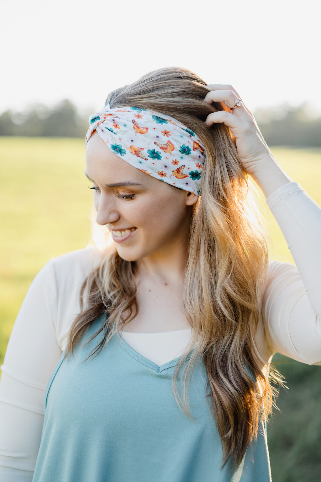 Hen & Harvest headband worn confidently by a woman with long hair, highlighting its twist style and versatility for workouts, long shifts, or play days.