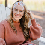 Woman wearing the Flourish headband, showcasing its versatile 3-in-1 twist style and cozy fall charm, part of The Jen Hamilton Collection.