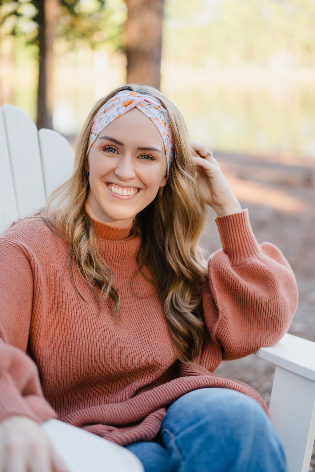 Woman wearing the Flourish headband, showcasing its versatile 3-in-1 twist style and cozy fall charm, part of The Jen Hamilton Collection.