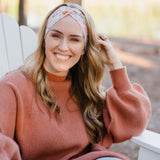 Woman wearing the Flourish headband, showcasing its versatile 3-in-1 twist style and cozy fall charm, part of The Jen Hamilton Collection.