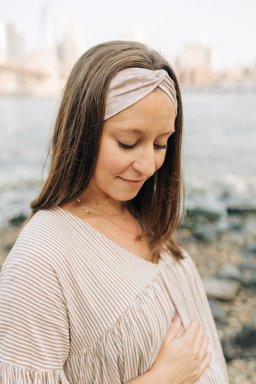 Woman wearing Unconditional headband from The Sarah Wallace Collection. Headband is versatile, non-slip, and sweat absorbent, perfect for various activities.