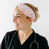 A nurse smiling with hair pinned up while wearing the I'm Just Here For The Free Gloves headband for cute hairstyles and comfortable all-day wear.
