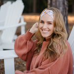 Woman wearing the Flourish headband, showcasing its versatile 3-in-1 twist style and cozy fall charm, part of The Jen Hamilton Collection.