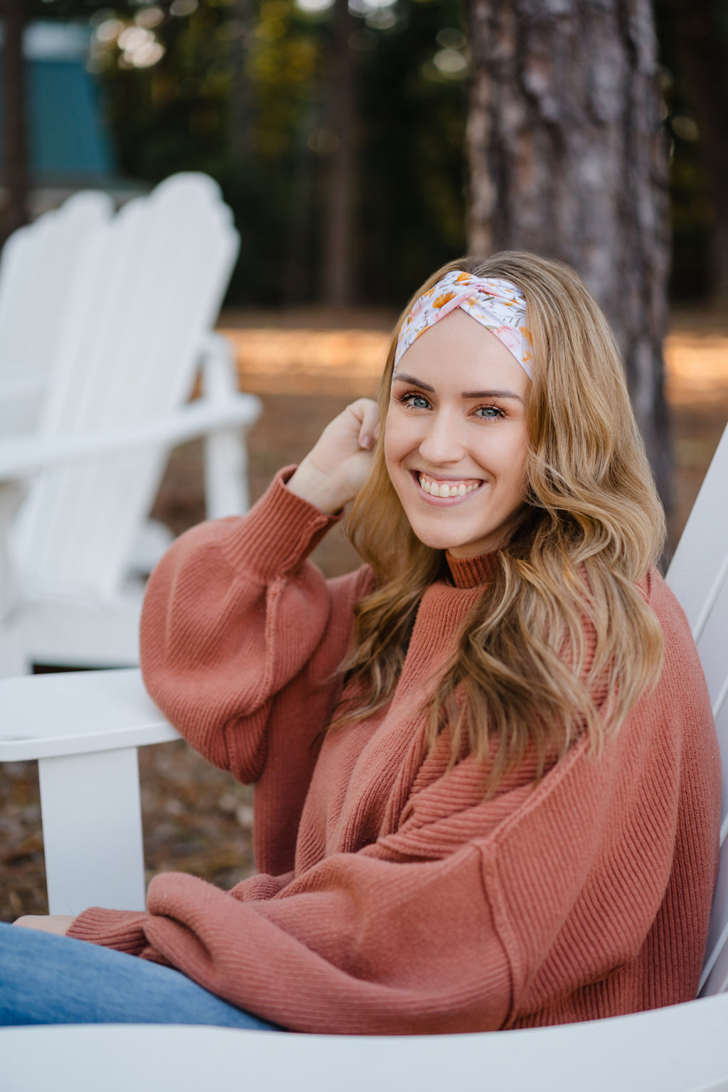 Woman wearing the Flourish headband, showcasing its versatile 3-in-1 twist style and cozy fall charm, part of The Jen Hamilton Collection.