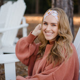 Woman wearing the Flourish headband, showcasing its versatile 3-in-1 twist style and cozy fall charm, part of The Jen Hamilton Collection.