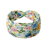 Hope Floral on Ivory headband featuring hand-drawn blue, pink, orange and green flowers, crafted from a buttery-soft, ultra-stretchy poly-knit blend, designed for versatility and comfort.