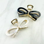 Treat Yourself Lilac Clip, a glossy 4-inch claw clip with hinge closure, available in two color options of white or black, perfect for keeping hair in place.