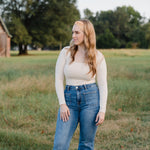 Woman smiling outdoors, wearing the Bring the Weather headband from The Jen Hamilton Collection, showcasing its versatile, non-slip, buttery-soft design.