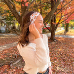 Woman smiling confidently in front of a tree, wearing the Sweet as Pie headband by Lilac Market Headbands, showcasing its versatile, non-slip design.