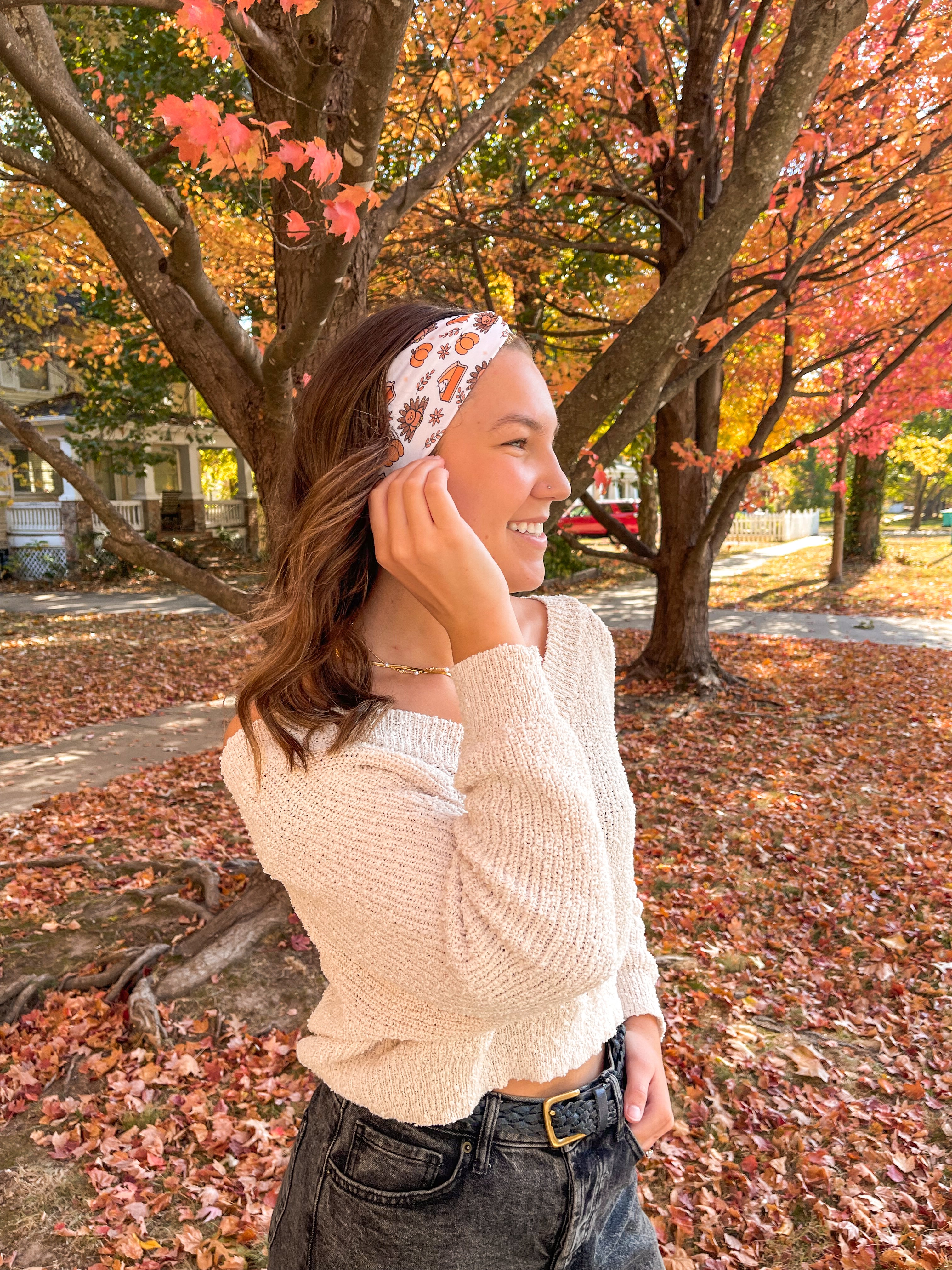 Woman smiling confidently in front of a tree, wearing the Sweet as Pie headband by Lilac Market Headbands, showcasing its versatile, non-slip design.