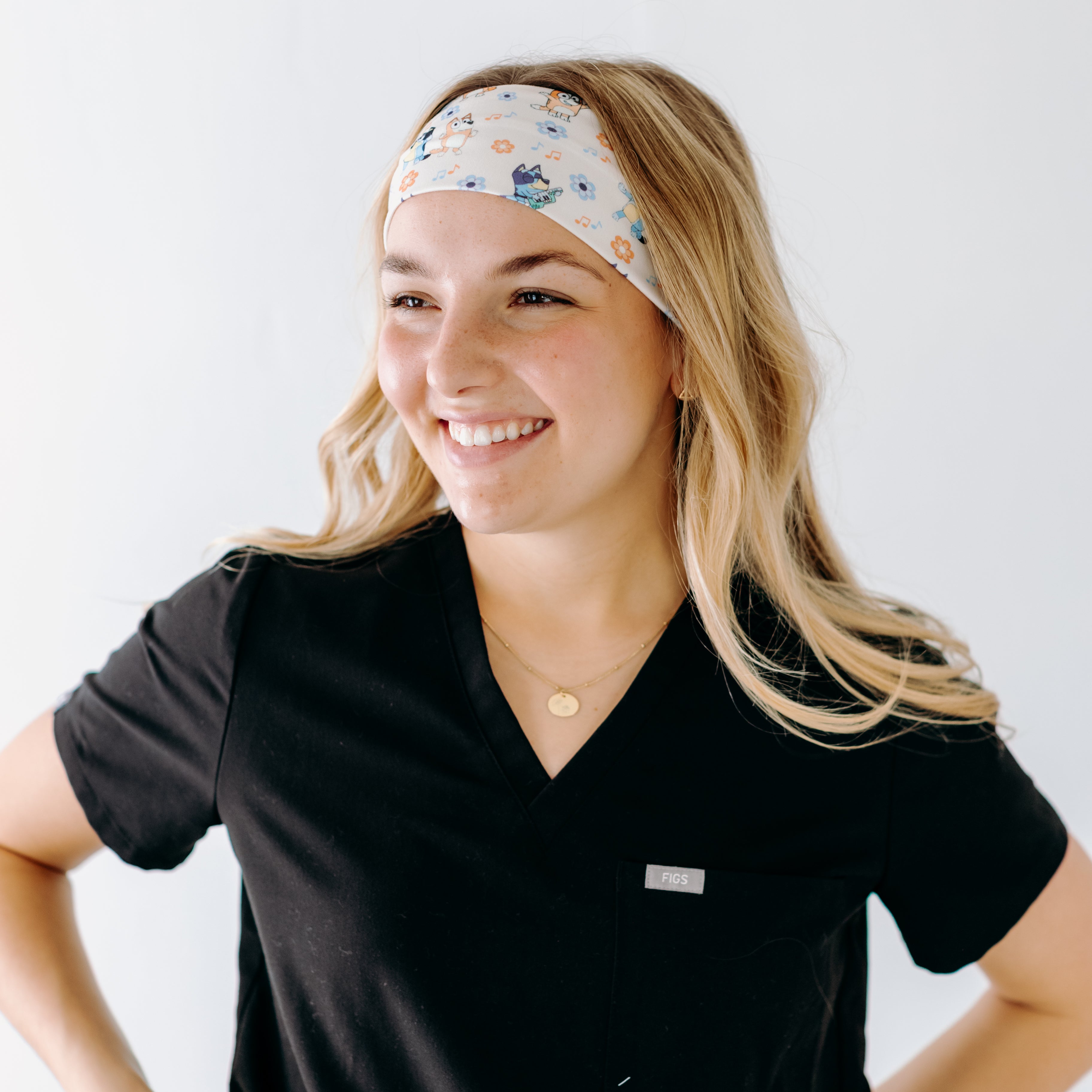 A nurse smiling with long hair while wearing theHeeler at Heart headband for cute hairstyles and comfortable all-day wear.