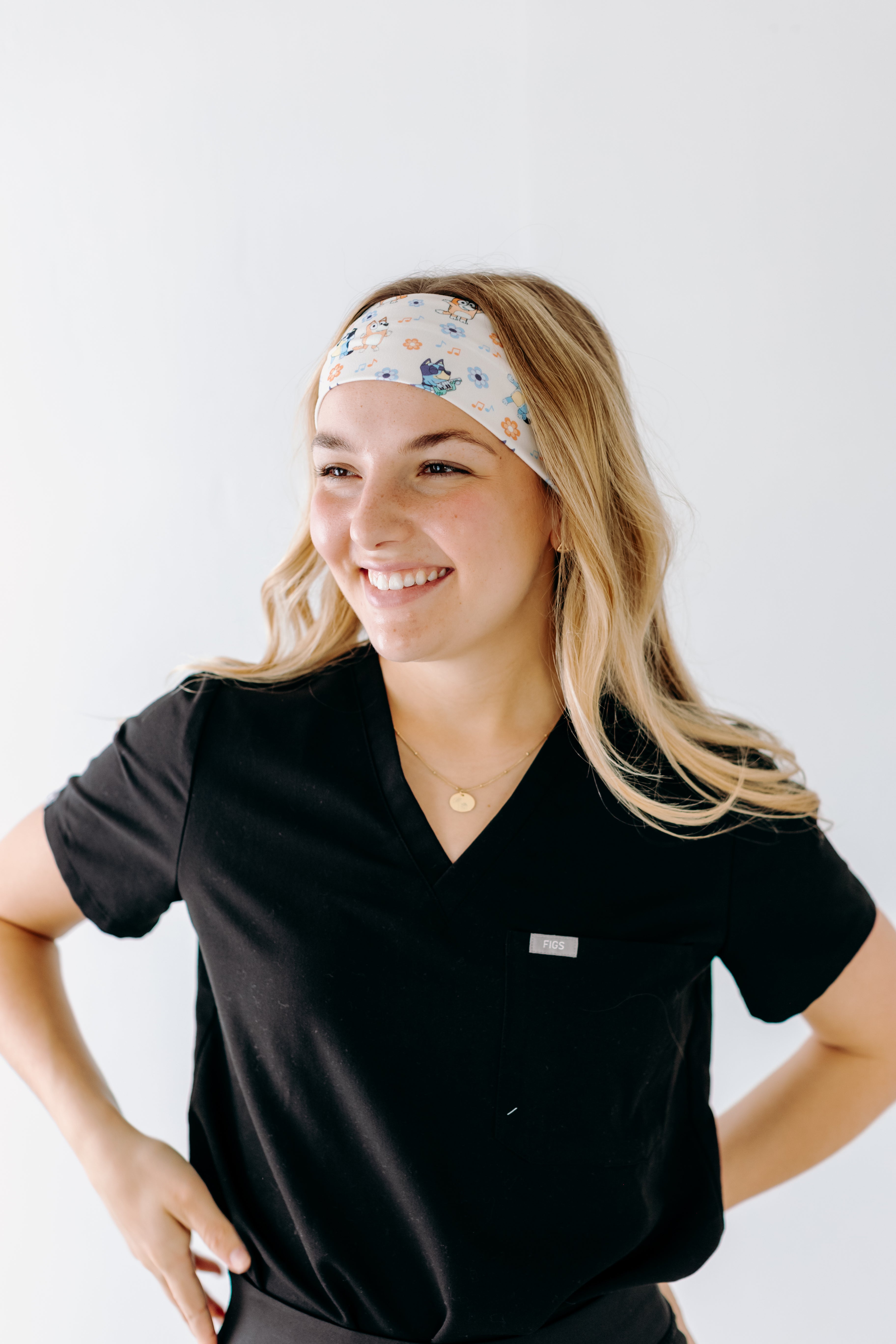 A nurse smiling with long hair while wearing theHeeler at Heart headband for cute hairstyles and comfortable all-day wear.