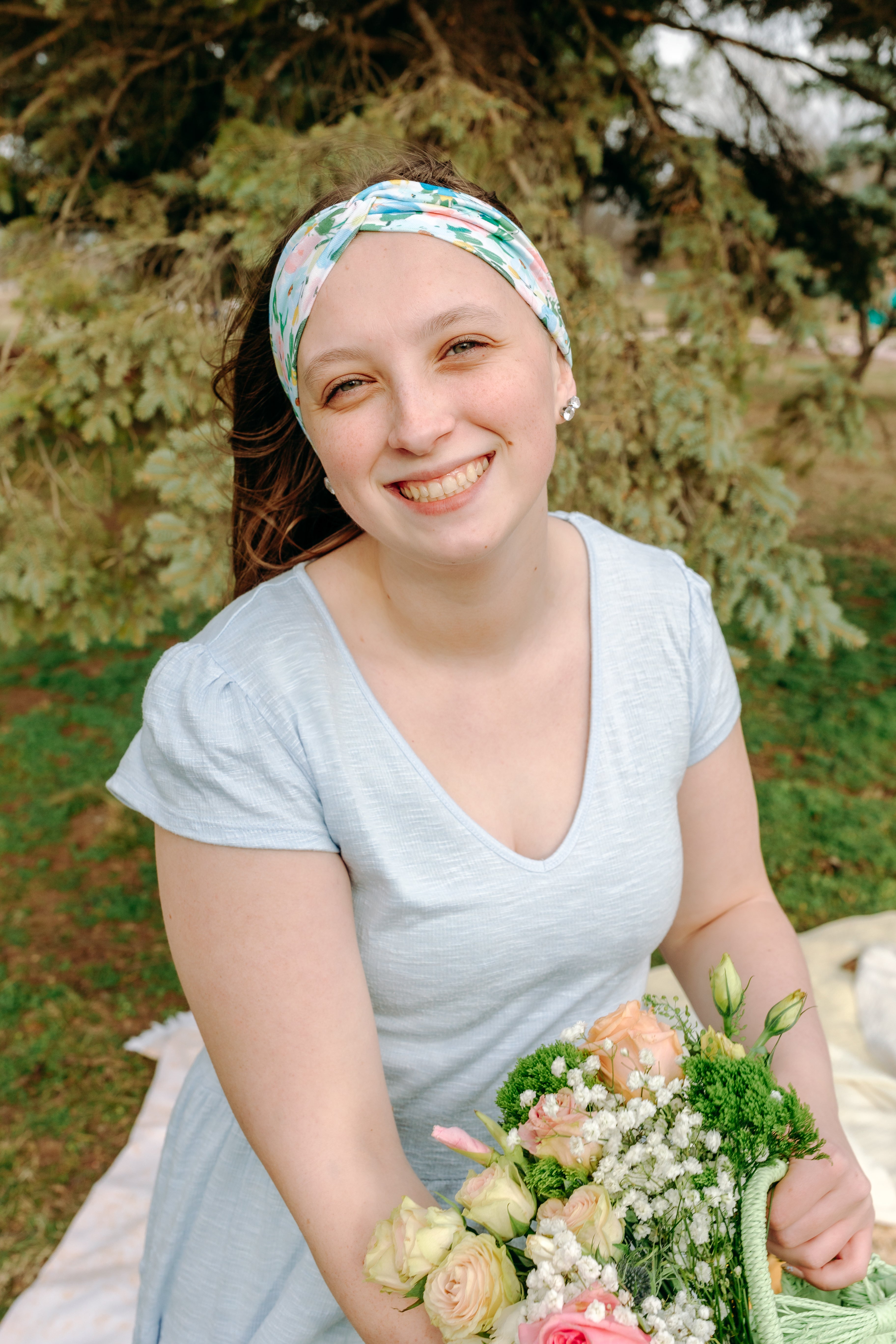 Woman smiling while wearing the Hope Floral on Ivory headband, the perfect non-slip accessory for work or workouts.