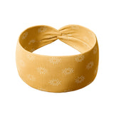Bring the Weather headband featuring a golden yellow headband with white sun designs, ultra-stretchy material, and a versatile twist style for comfort and charm from The Jen Hamilton Collection.