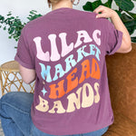Adult women's vintage berry colored oversized tee shirt with a small Lilac Market logo on the front and a 70's vintage print saying "Lilac Market Headbands" in orange, blue, tan and lilac on the back