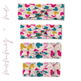 Multiple sizes of the I'm All Ears - Mommy & Me twist knot headbands with Mickey Mouse head pattern, perfect for matching family sets with adjustable bow for toddler and baby sizes.