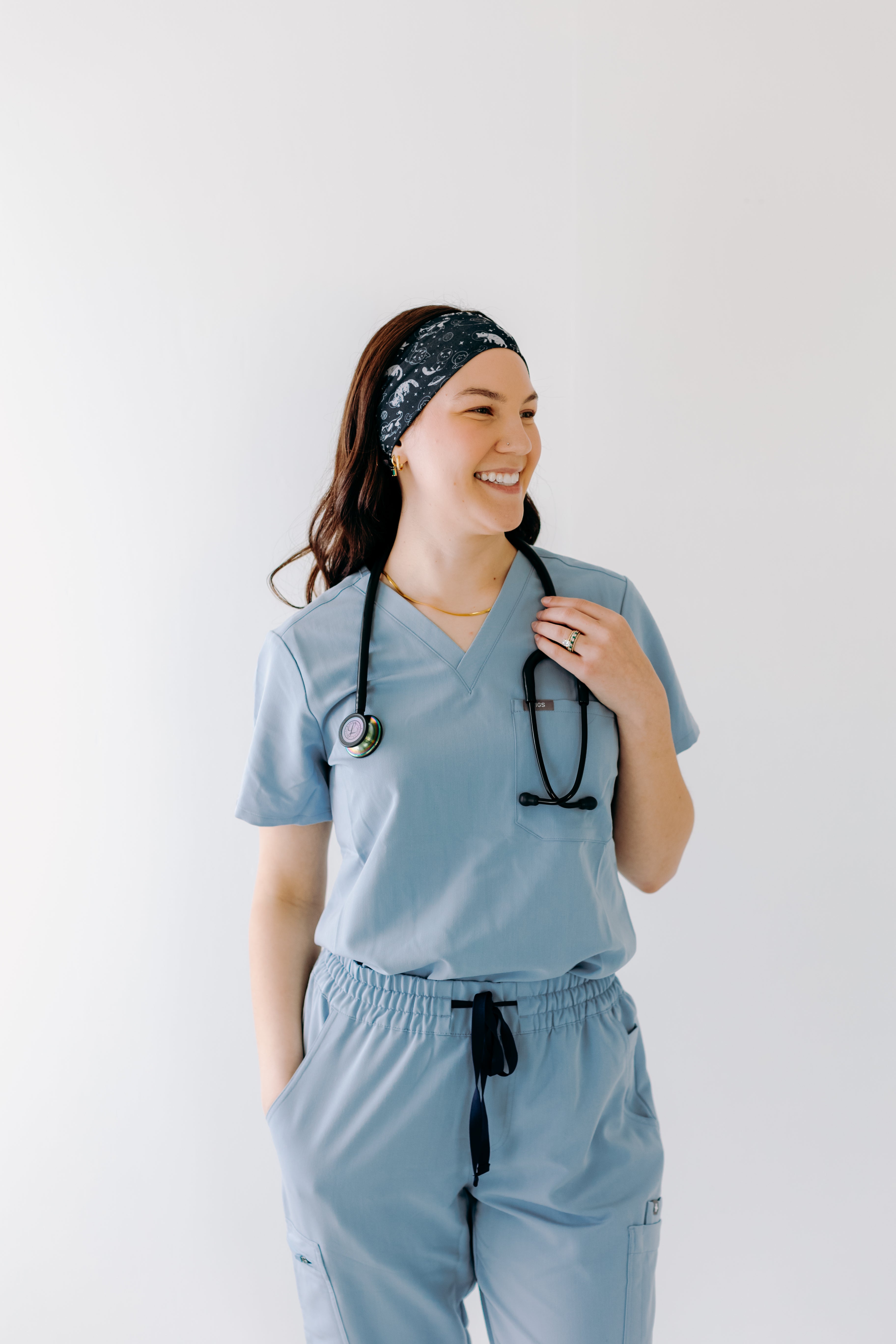 A nurse smiling with long hair while wearing the Gimme Some Space for cute hairstyles and comfortable all-day wear.