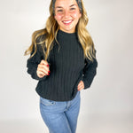 Woman wearing The Enchanted Garden headband, showcasing its versatile 3-in-1 twist style and buttery-soft, non-slip fabric, ideal for work or play.