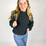 Woman wearing The Enchanted Garden headband, showcasing its versatile 3-in-1 twist style and buttery-soft, non-slip fabric, ideal for work or play.