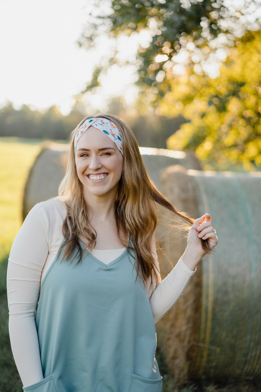 Hen & Harvest headband worn confidently by a woman with long hair, highlighting its twist style and versatility for workouts, long shifts, or play days.